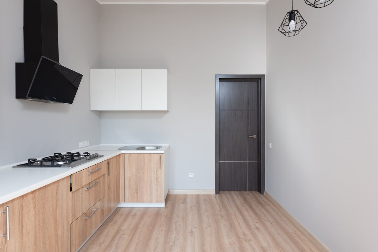 Sleek modern kitchen design featuring wooden cabinets and minimalist style.